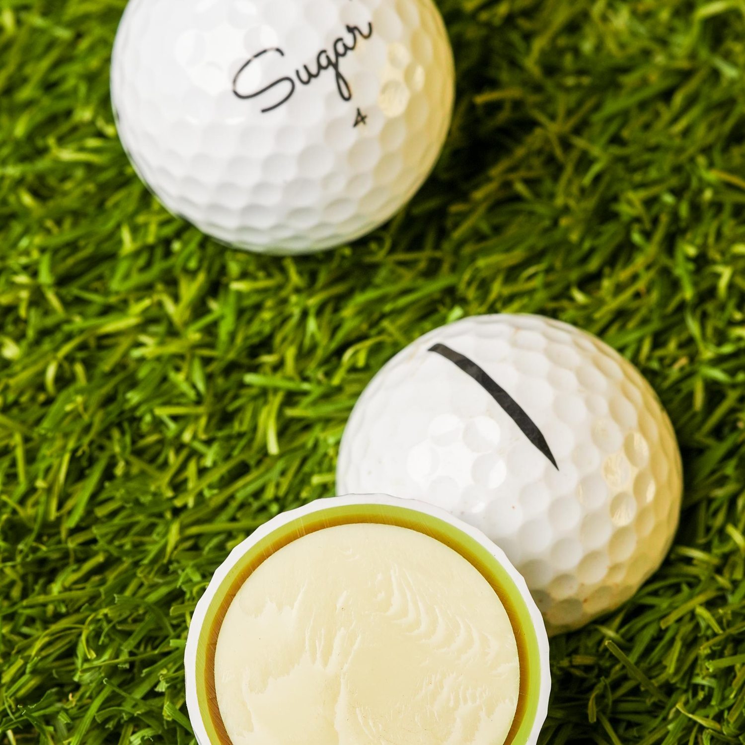 A Sugar ball beside one cut open, showing the solid inner core