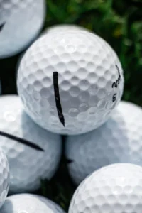 The Sugar Pure 3-piece urethane golf ball showing a clean, solid factory-stamped built-in alignment line for consistent aim on the green.