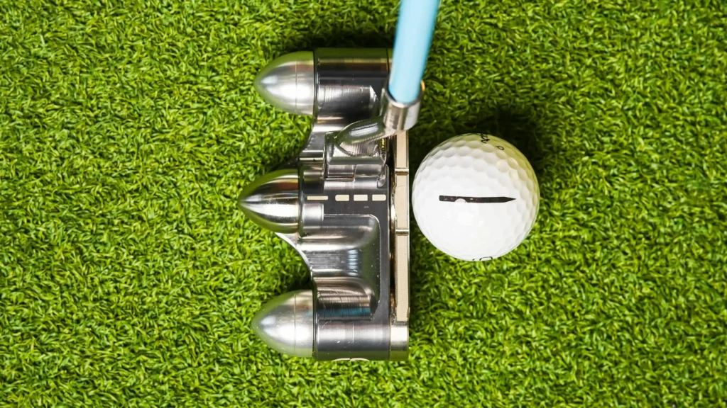 A putter lined up with a Sugar Golf Ball with a built-in alignment aid.