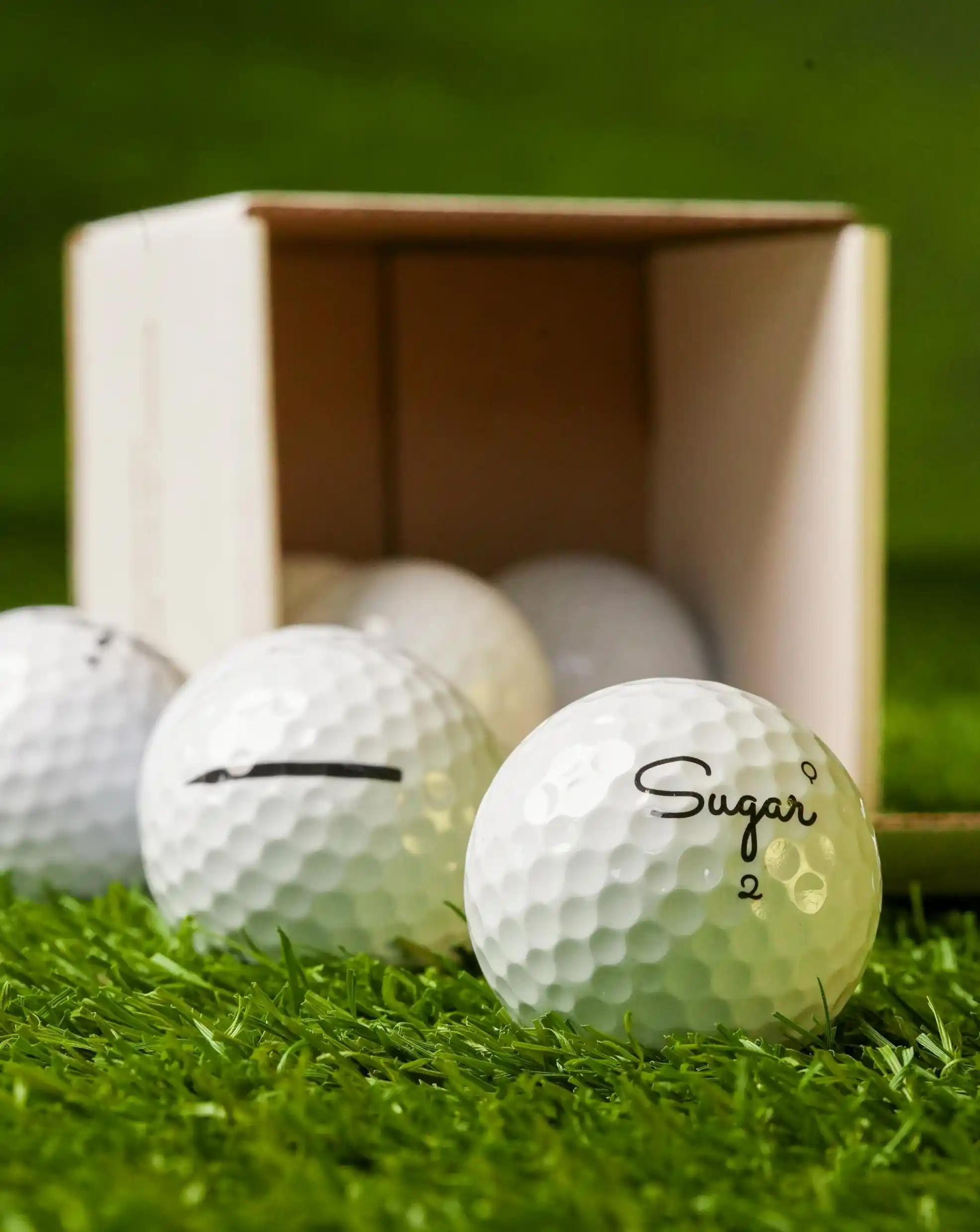 An open box of 8 Sugar Soft alignment golf balls.