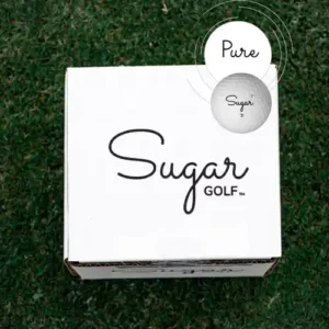A white box of 8 Sugar Pure affordable 3-piece urethane golf balls sitting on green grass.